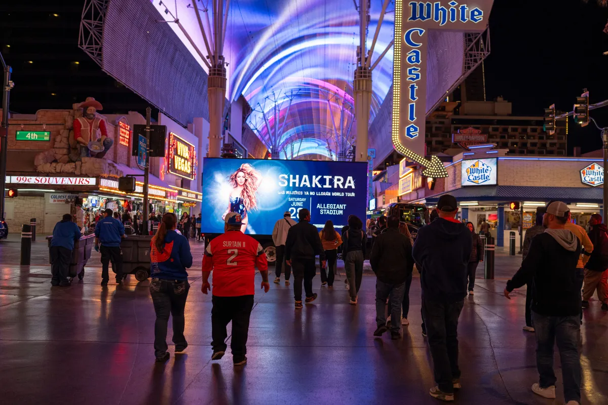 LED mobile billboard truck promoting a concert event on Fremont Street with vibrant nighttime crowd